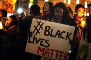 A person holding up a Black Lives Matter sign at a protest.