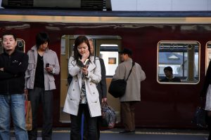 A person reading on a train platform.