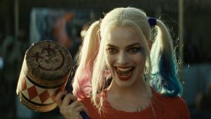 Harley Quinn holding a hammer and looking menacing.