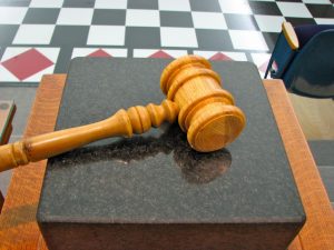 A gavel lying on a block.