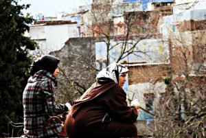 Two women sitting on the street in Morocco.