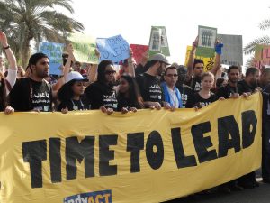 Protesters carrying a TIME TO LEAD sign