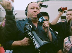 Alex Jones carrying a bullhorn