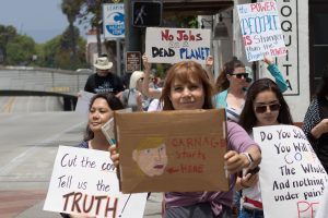 Participants in the March for Truth waving signs.