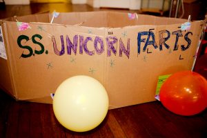 A cardboard boat named the SS Unicorn Farts