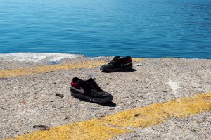 Two shoes on a dock.