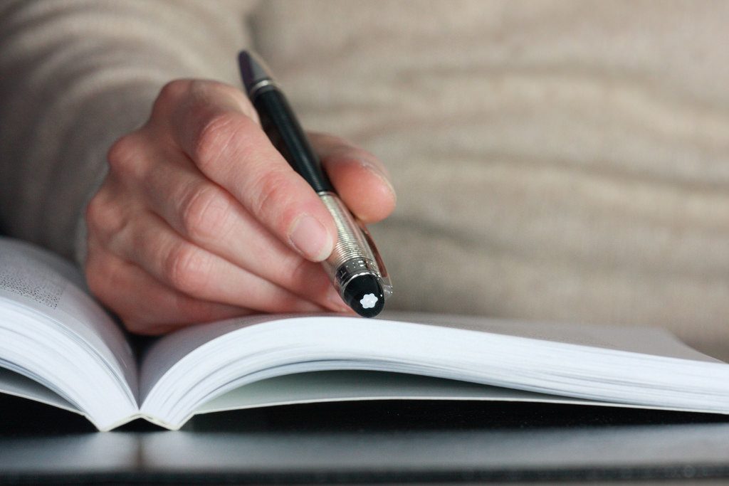 A person reading a notebook.