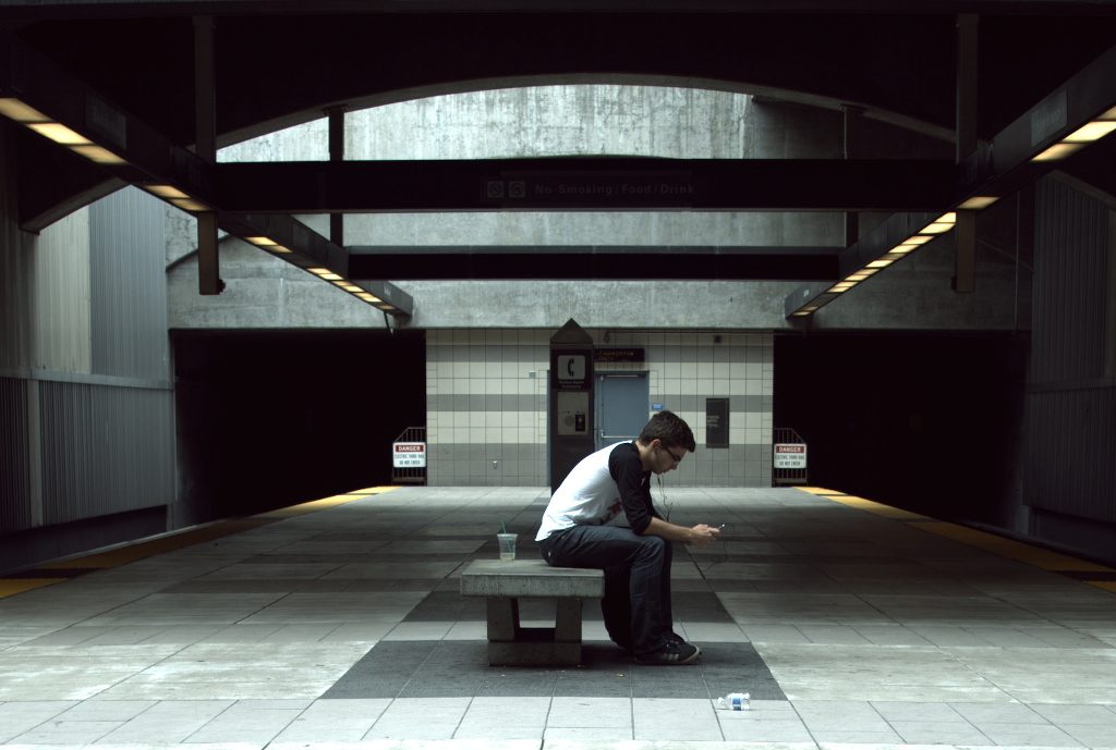 A person reading alone in a BART station.