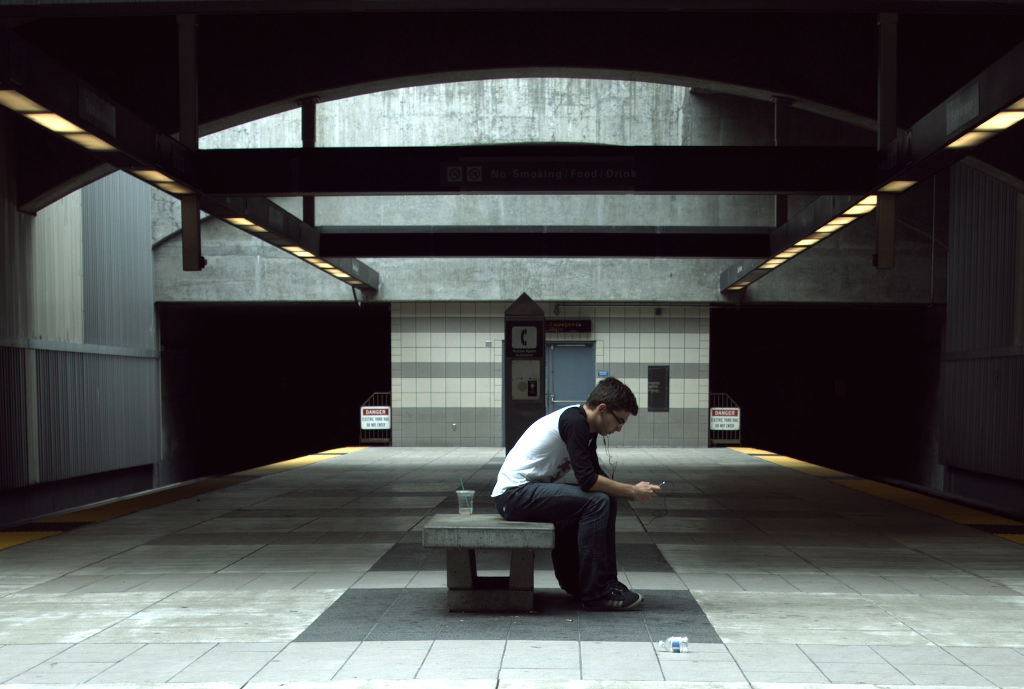 A person reading alone in a BART station.
