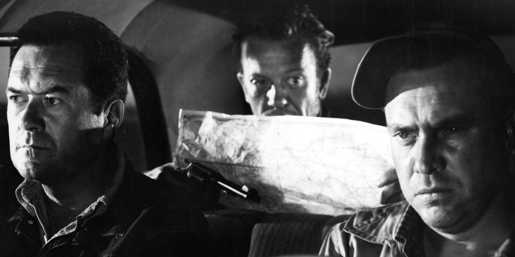A still from The Hitchhiker, showing the three characters trapped in a car.