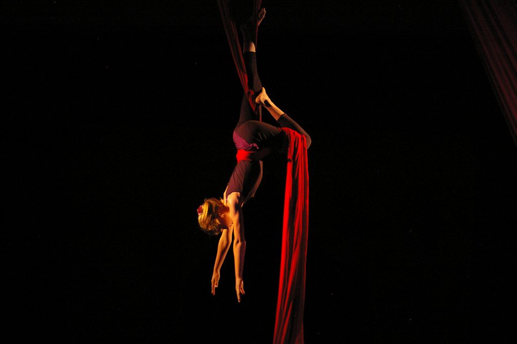 An aerial performer suspended upside down