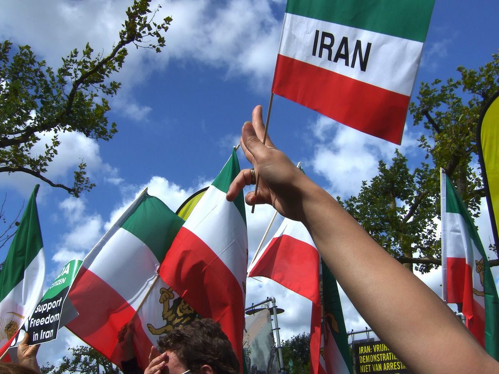 People waving Iranian flags
