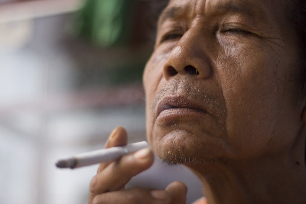 an indonesian man smoking